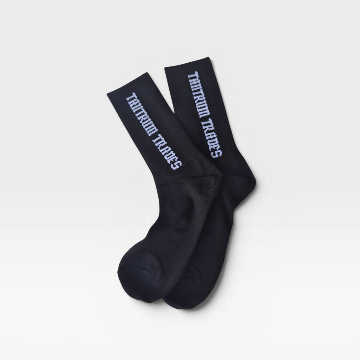 Black crew sock with 'TANTRUM TRADES' logo on cuff on white studio background.
