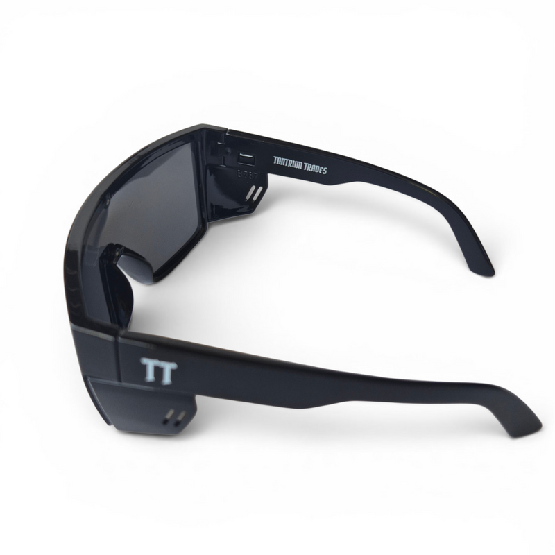 Black safety sunglasses with a wraparound frame, dark lenses, and a white 'TT' logo on the temple, and inside arm 'TANTRUM TRADES' logo shown on a white background.